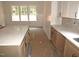 Modern kitchen featuring a large island, white and wood cabinets, and bright countertops at 1155 Shonele Ln, Stem, NC 27581
