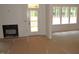 Bright living room featuring a fireplace, bright windows, and a door to the outdoor area at 1155 Shonele Ln, Stem, NC 27581
