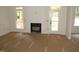 Spacious living room featuring a fireplace, bright windows, and a door to the outdoor area at 1155 Shonele Ln, Stem, NC 27581