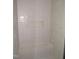 Modern tiled shower featuring a built-in bench and shower niche at 1155 Shonele Ln, Stem, NC 27581