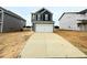 Stylish two-story home with a wide driveway leading to a two-car garage and grey horizontal siding at 120 Bruce Dr, Dunn, NC 28334