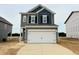 Charming two-story home featuring a two-car garage and neutral-tone siding, ready for its new owners at 120 Bruce Dr, Dunn, NC 28334