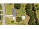 An aerial view of the home and property nestled among mature trees and grassy fields at 12082 Nc 42, Fuquay Varina, NC 27526