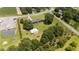 Aerial view of the home and property with a spacious yard, trees, and buildings at 12082 Nc 42, Fuquay Varina, NC 27526