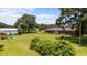 Expansive backyard featuring a brick home, lush lawn, playset and large outbuilding at 12082 Nc 42, Fuquay Varina, NC 27526