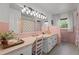 Vintage bathroom features pink tiling, ample countertop space, and large mirror at 12082 Nc 42, Fuquay Varina, NC 27526