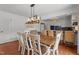 Elegant dining room featuring a modern chandelier and view to kitchen at 12082 Nc 42, Fuquay Varina, NC 27526