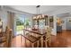 Lovely dining room with wooden table, bench seating and natural light pouring through large windows at 12082 Nc 42, Fuquay Varina, NC 27526