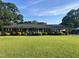 Well-maintained single-story brick home featuring a lush front yard with manicured landscaping at 12082 Nc 42, Fuquay Varina, NC 27526