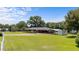 Wide shot of exterior brick home, expansive lawn, and sunny skies at 12082 Nc 42, Fuquay Varina, NC 27526