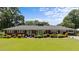Beautiful brick home with a lush green lawn and mature trees in a serene setting at 12082 Nc 42, Fuquay Varina, NC 27526