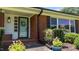 Inviting front entrance with a stylish door, brick accents, and manicured landscaping at 12082 Nc 42, Fuquay Varina, NC 27526
