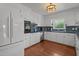 Bright kitchen with white cabinetry, tile backsplash, and a full range of modern appliances at 12082 Nc 42, Fuquay Varina, NC 27526