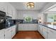 Well-lit kitchen with white cabinetry, dark countertops and stainless steel appliances at 12082 Nc 42, Fuquay Varina, NC 27526