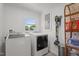 Bright laundry room with modern washer and dryer and storage at 12082 Nc 42, Fuquay Varina, NC 27526