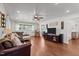 Inviting living room with hardwood floors, ceiling fan and natural light at 12082 Nc 42, Fuquay Varina, NC 27526