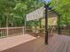Inviting back deck featuring a shaded pergola, perfect for outdoor entertaining surrounded by lush greenery at 128 Castlewood Dr, Cary, NC 27511