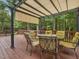 Inviting back deck featuring a shaded pergola, perfect for outdoor entertaining surrounded by lush greenery at 128 Castlewood Dr, Cary, NC 27511