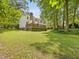 Home's backyard featuring a large deck and ample green space at 128 Castlewood Dr, Cary, NC 27511