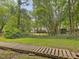 Backyard view with deck, surrounded by trees and nature, offering privacy at 128 Castlewood Dr, Cary, NC 27511