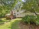 View of the home's backyard with a wooden deck and lush landscaping at 128 Castlewood Dr, Cary, NC 27511
