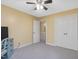 Bedroom features neutral walls, carpet flooring, ceiling fan, and closet at 128 Castlewood Dr, Cary, NC 27511