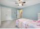 Bedroom features carpet flooring, ceiling fan, and large closet at 128 Castlewood Dr, Cary, NC 27511