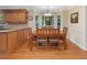 Bright dining area features wood floors, matching table and chairs, and natural light from windows at 128 Castlewood Dr, Cary, NC 27511