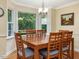Bright dining area features wood floors, a large window with green views, and seating for six at 128 Castlewood Dr, Cary, NC 27511