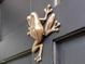 Close-up of a unique frog door knocker on a black front door, adding a touch of whimsy at 128 Castlewood Dr, Cary, NC 27511