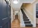 Open foyer showcasing hardwood floors, a staircase, and a view into the dining room at 128 Castlewood Dr, Cary, NC 27511