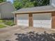 Exterior view of the attached two car garage with brick veneer at 128 Castlewood Dr, Cary, NC 27511