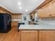 Spacious kitchen boasts granite countertops, a center island, and stainless steel appliances at 128 Castlewood Dr, Cary, NC 27511