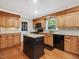 Updated kitchen offers granite countertops, a center island, and plenty of cabinet space at 128 Castlewood Dr, Cary, NC 27511