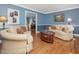 Bright living room with hardwood floors, comfortable sofas, and elegant decor, perfect for relaxation at 128 Castlewood Dr, Cary, NC 27511