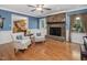 Comfortable living room showcasing a brick fireplace, hardwood flooring, and classic design at 128 Castlewood Dr, Cary, NC 27511