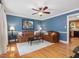 Warm living room features hardwood floors, dark furniture, and blue walls for a cozy setting at 128 Castlewood Dr, Cary, NC 27511
