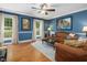 Spacious living room featuring hardwood floors, comfortable sofas, and large windows for ample light at 128 Castlewood Dr, Cary, NC 27511