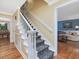 Entryway with hardwood floors and a staircase leading to the upper level and views into the living room at 128 Castlewood Dr, Cary, NC 27511