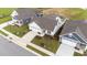 Aerial view of a home featuring a well-maintained lawn, lush landscaping, and a private driveway at 1319 Richfield Oaks Dr, Fuquay Varina, NC 27526