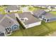 A backyard with an iron fence and patio cover is surrounded by mature landscaping and lawn at 1319 Richfield Oaks Dr, Fuquay Varina, NC 27526