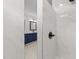 Contemporary bathroom with tiled shower and navy double vanity and mirrors, exuding modern design at 1319 Richfield Oaks Dr, Fuquay Varina, NC 27526