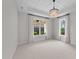 Bright bedroom features an ornamental light fixture and large windows at 1319 Richfield Oaks Dr, Fuquay Varina, NC 27526