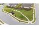 A common area walking path meanders through the green lawn and landscaping that includes benches and walkways at 1319 Richfield Oaks Dr, Fuquay Varina, NC 27526