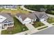 Beautiful white home featuring a two-car garage, a well-manicured lawn and meticulous landscaping at 1319 Richfield Oaks Dr, Fuquay Varina, NC 27526