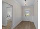 Elegant foyer with wainscoting, hardwood floors, decorative lighting, and views into adjacent rooms at 1319 Richfield Oaks Dr, Fuquay Varina, NC 27526