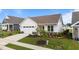 Beautiful front exterior with a well-manicured lawn, featuring a lush tree, and a white garage door at 1319 Richfield Oaks Dr, Fuquay Varina, NC 27526