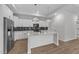 Modern kitchen features stainless steel appliances and white cabinets at 1319 Richfield Oaks Dr, Fuquay Varina, NC 27526