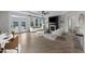 Bright living room with fireplace, large windows, and patio access; furniture shown for decorative purposes at 1319 Richfield Oaks Dr, Fuquay Varina, NC 27526