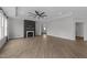 Large open living room with modern fireplace, recessed lighting, and wood-look flooring at 1319 Richfield Oaks Dr, Fuquay Varina, NC 27526